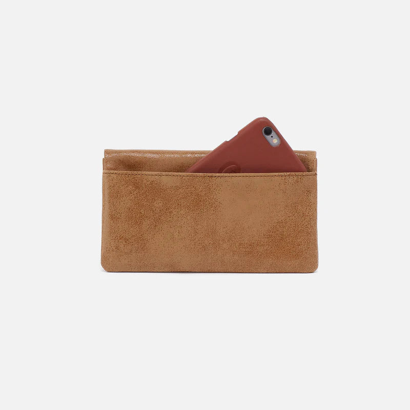 Lumen Continental Wallet in the color whiskey with a phone in the pocket