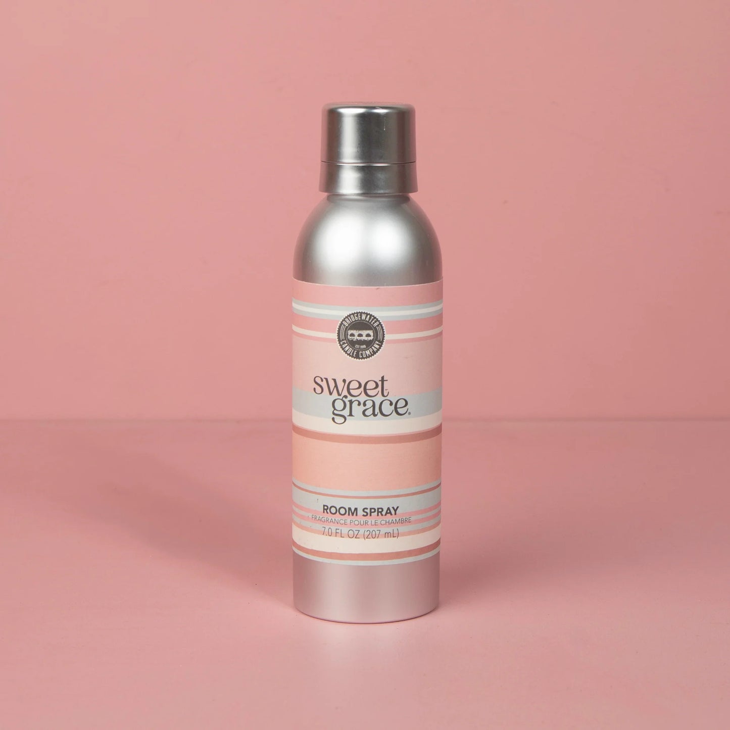 bottle of Sweet Grace Room Spray on a pink background