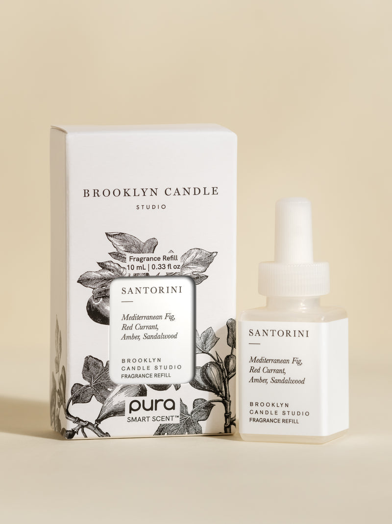 Pura Scents Santorini Smart Vial by Brooklyn Candle Studio set next to its box packaging on an off-white background.