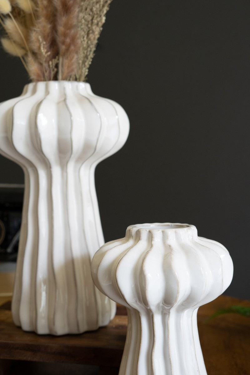 close-up of white ribbed vases
