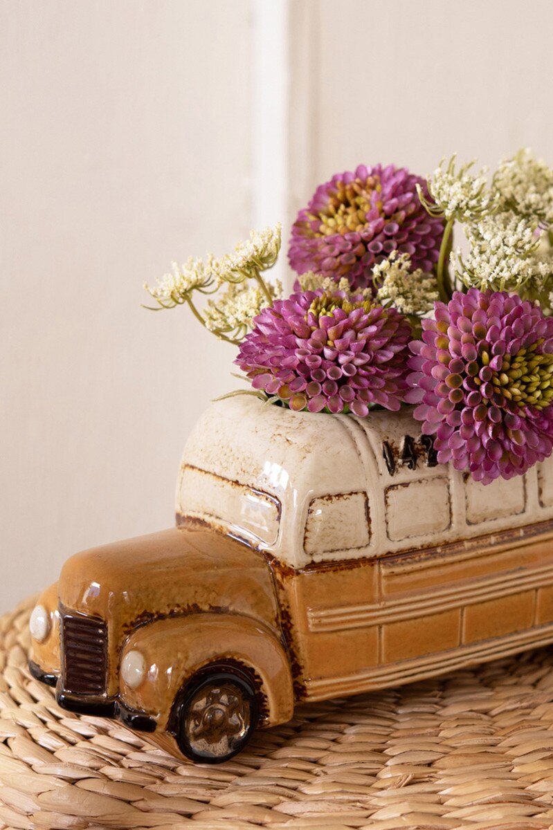 close-up of school bus planter filled with flowers