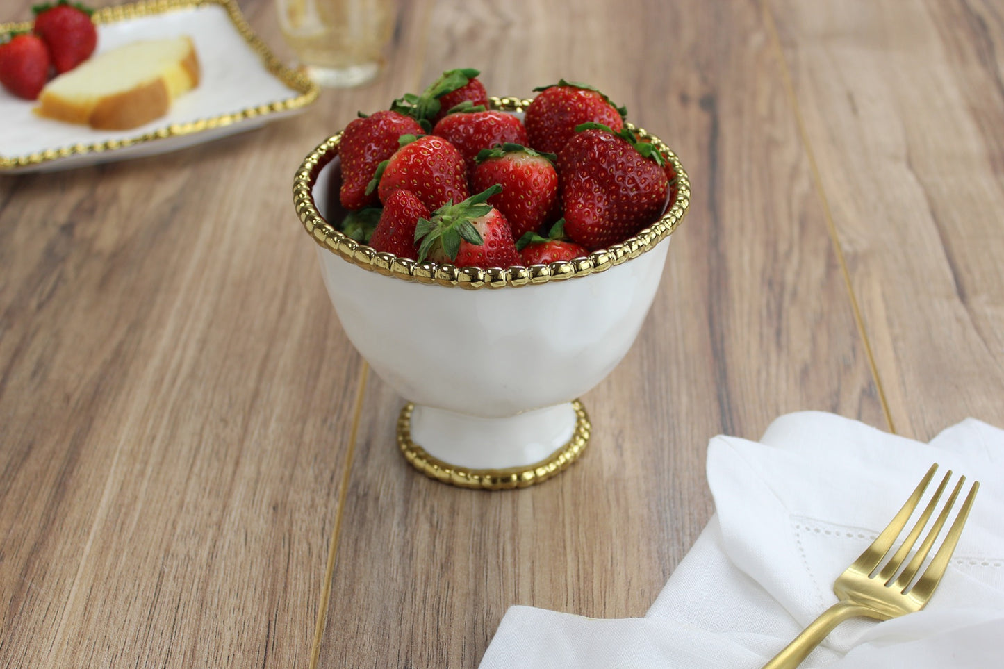 small footed bowl with fruit in it