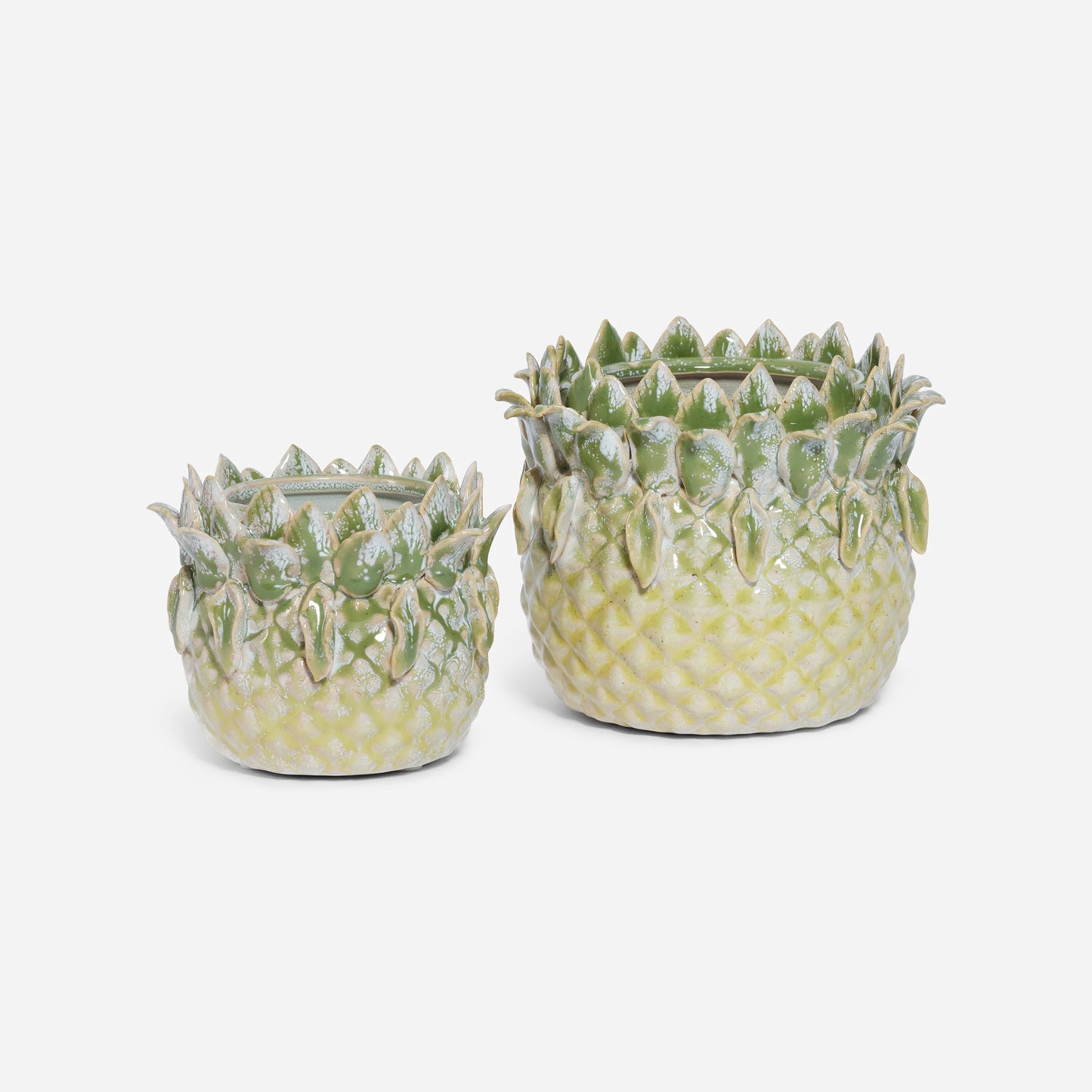 Two sizes of ceramic pineapple-shaped planters on a white background