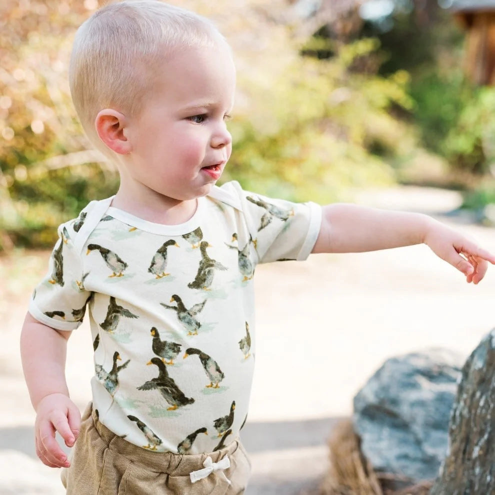 small child wearing duck one piece