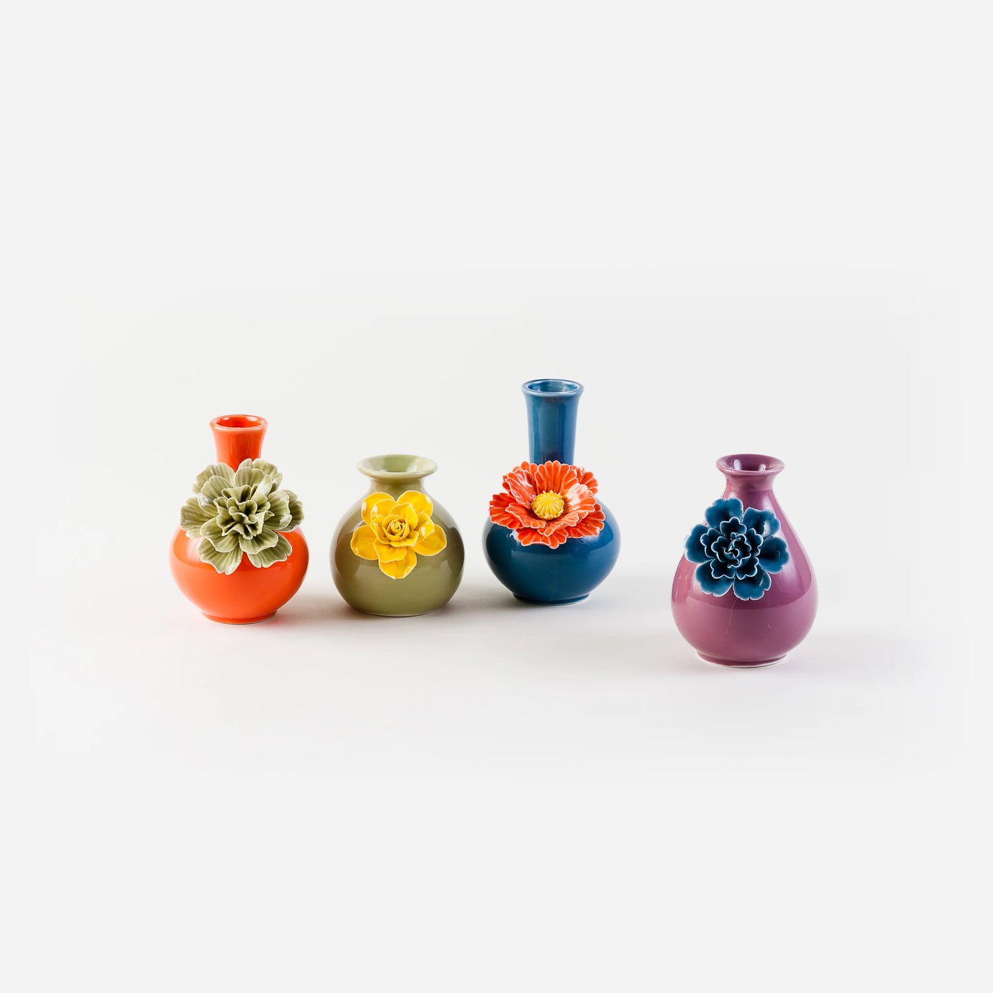 Four colorful vases with floral designs on a white background