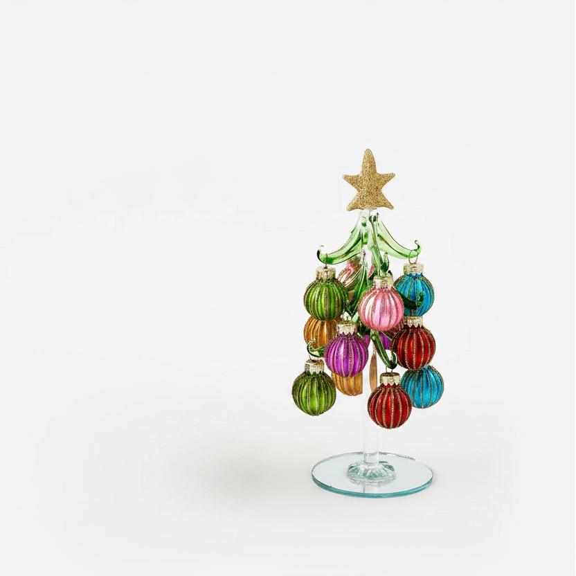 glass Christmas tree with colorful balls ornaments with diamond glitter pattern on them and gold star topper on it