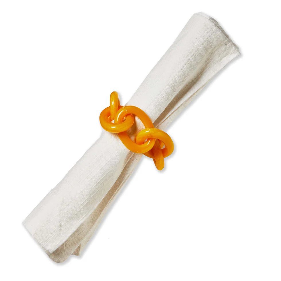 yellow links napkin ring on a white napkin.