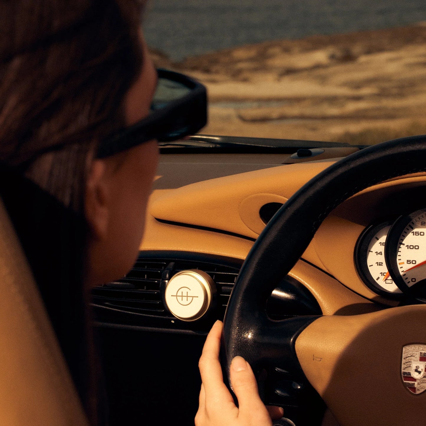 tahaa affair Car Diffuser clipped on a vent in a car driving along a coast