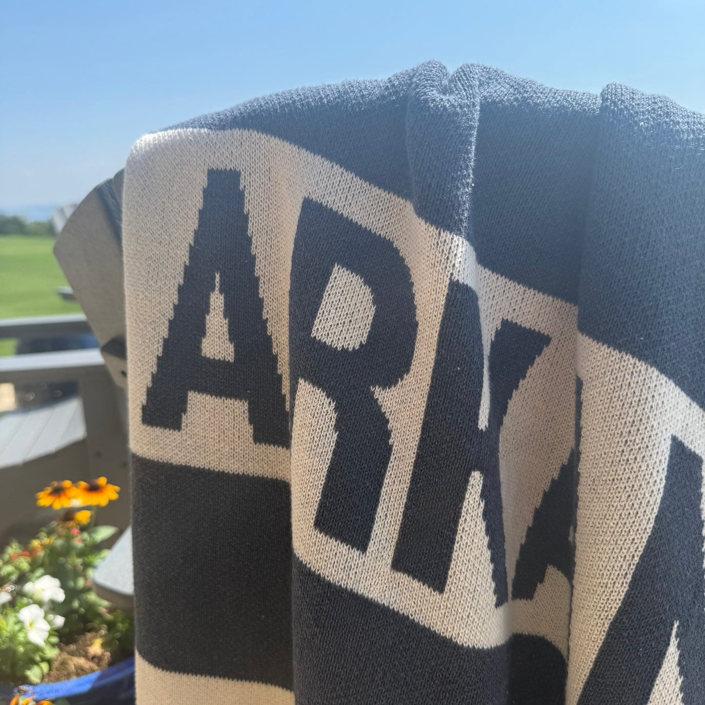 close-up of Arkansas knit blanket draped over a deck chair