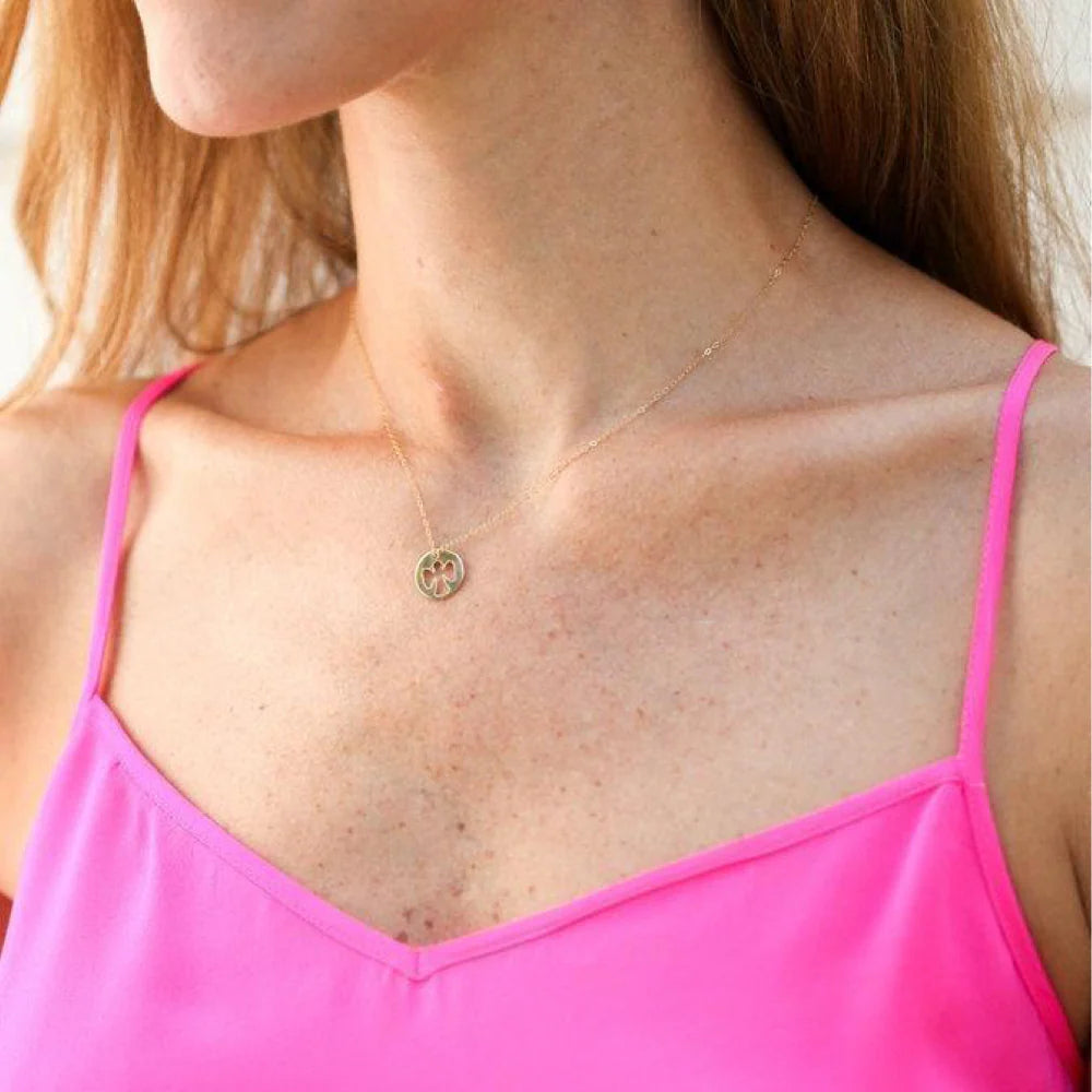 a person wearing the guardian angel gold disc necklace
