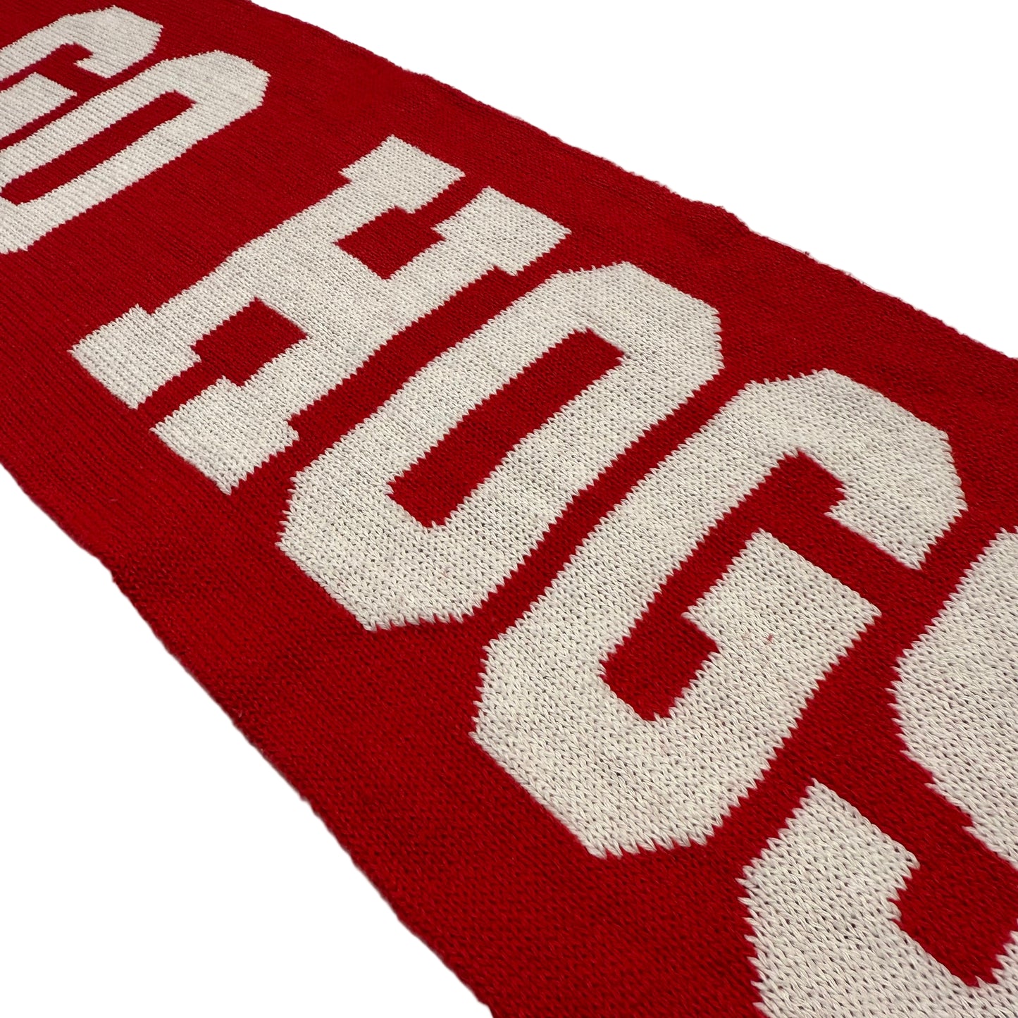 close-up of Red and white knitted scarf with 'GO HOGS' text on a white background