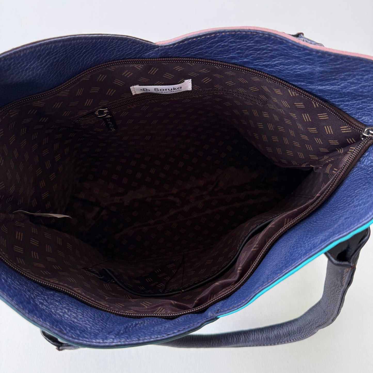 interior view of blue tote bag with patterned lining
