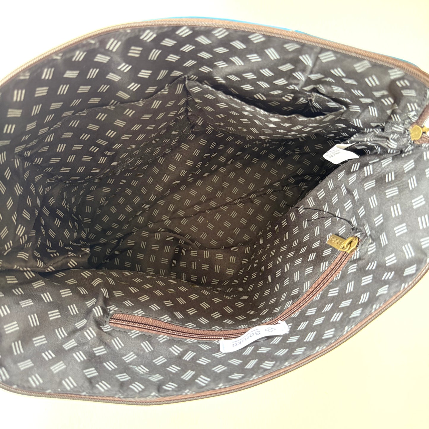 interior view of hand bag with patterned lining