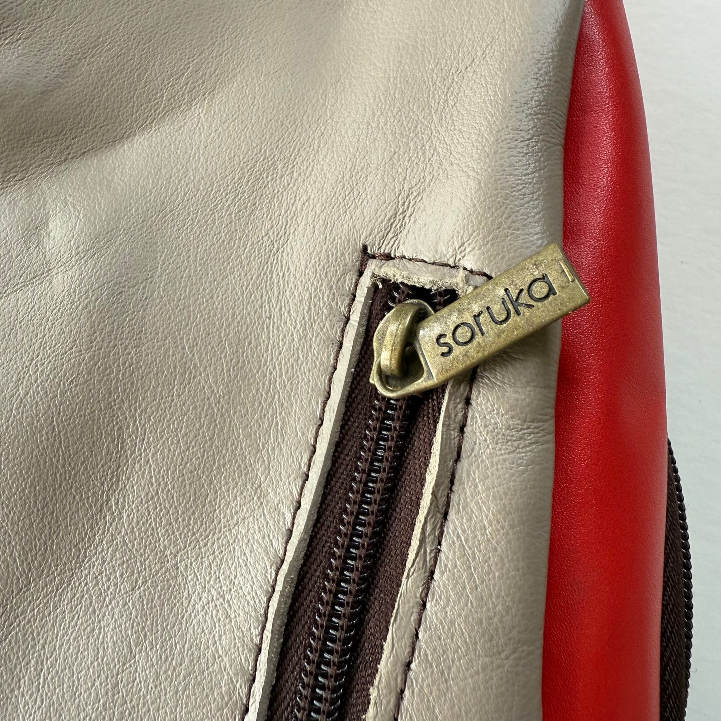 close-up of zipper pocket on back of sling bag