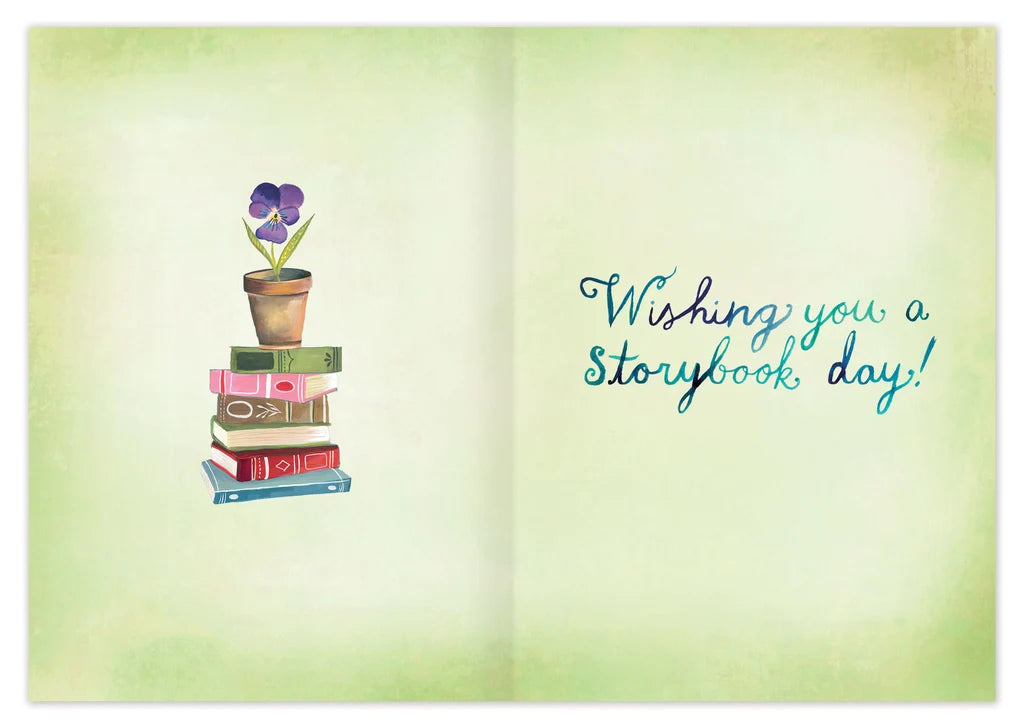 inside of card featuring a book stack and blue text