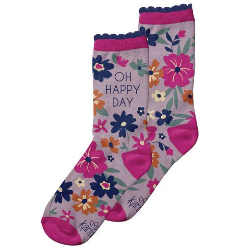 lavender socks with "oh happy day" and a floral design on them