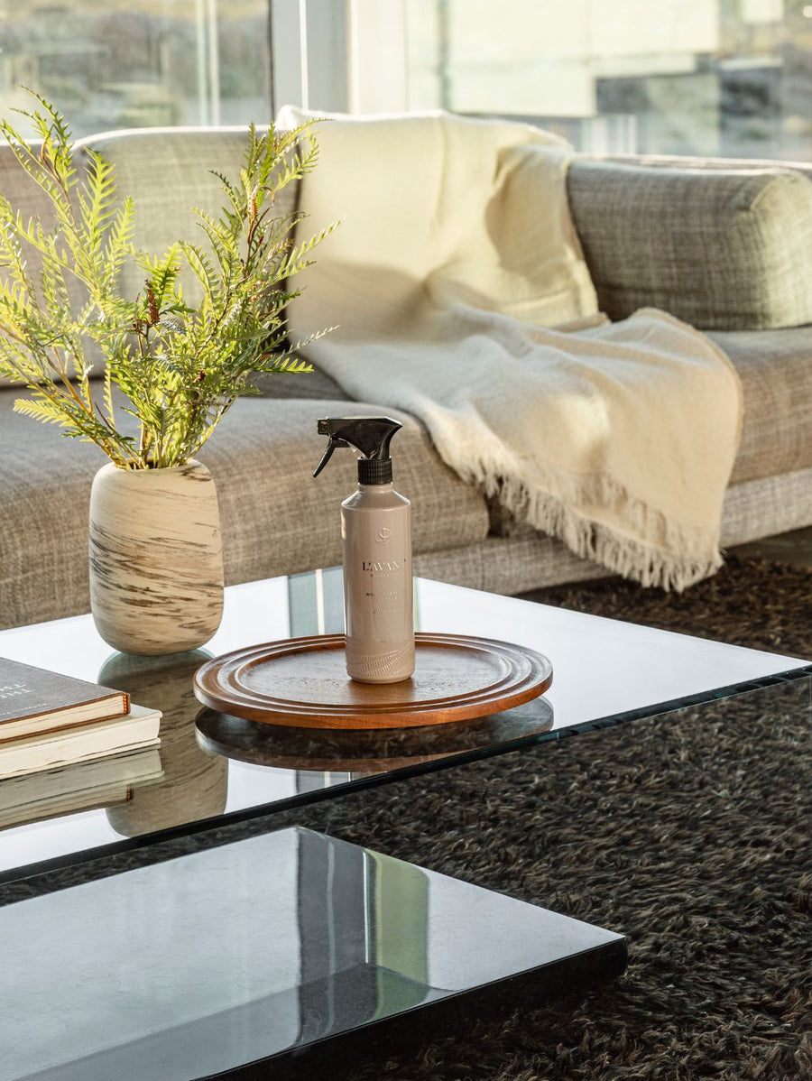 ambre santal cleaner on a coffee table in a decorated living room