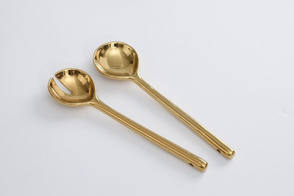 gold salad serving set on a white background.