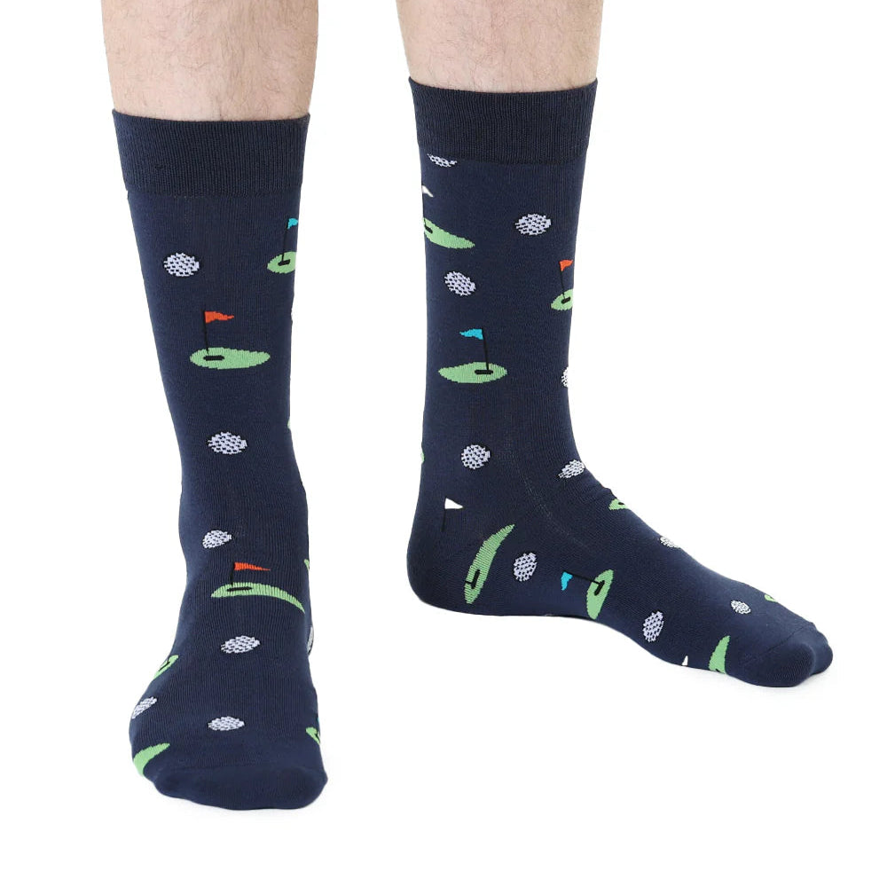 Navy socks with golf patterns worn by a person on a white background