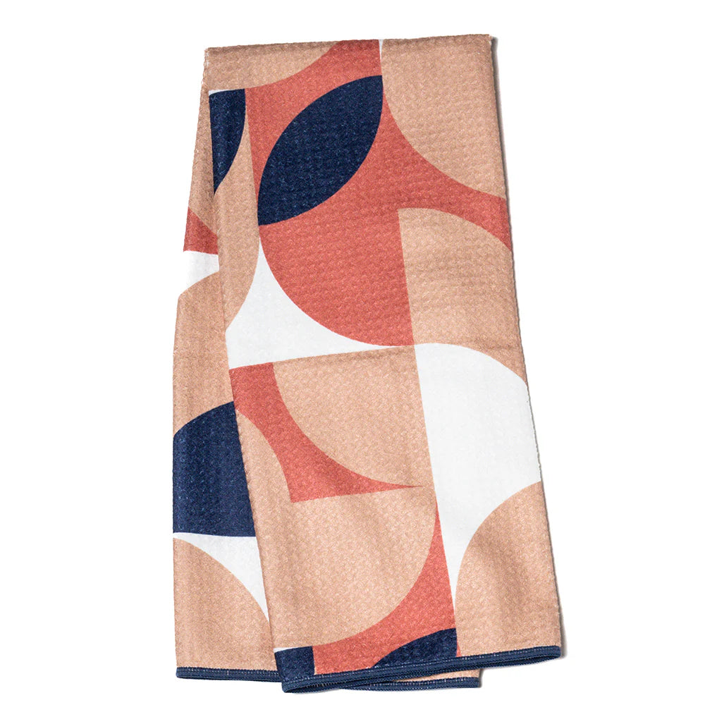 blush towel with circular graphics in coral, navy, and white.