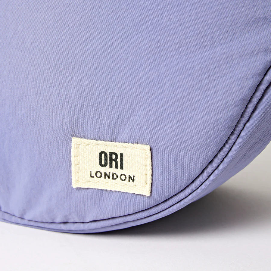 close-up of bottom corner of lavender bag with otri london lablel