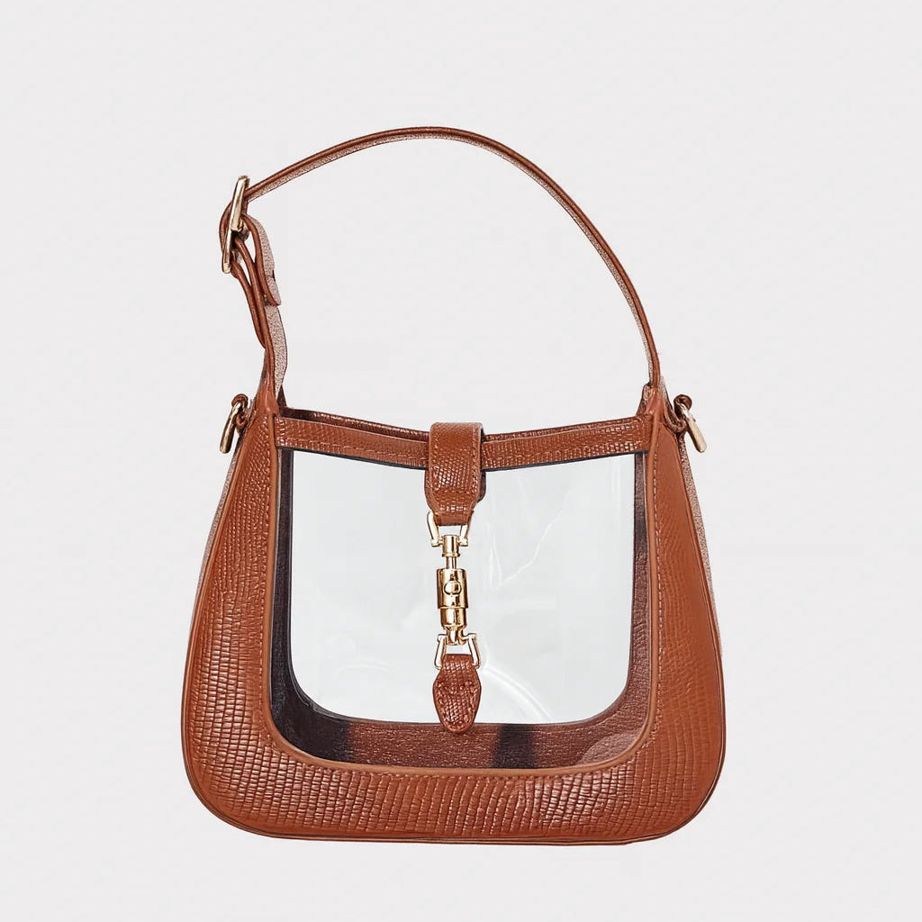 Clear handbag with brown trim and handle and gold latch shown on a white background