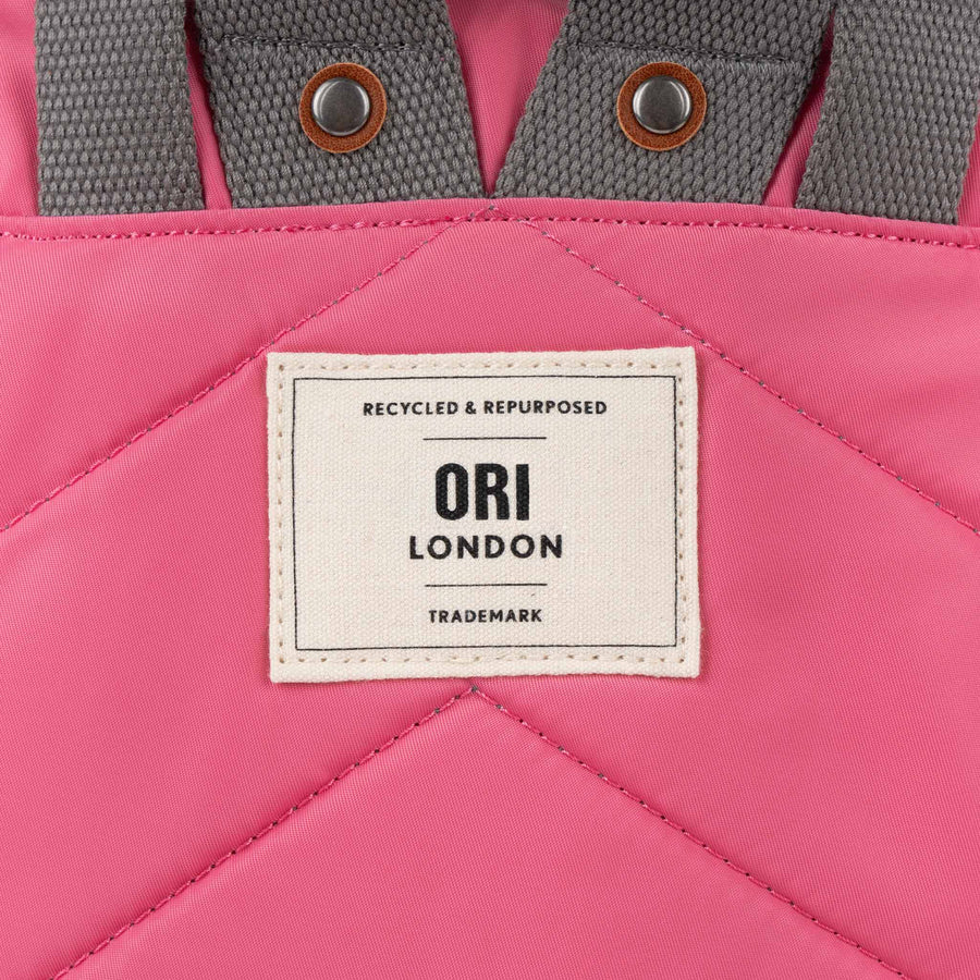 close-up of Baroque bantry b backpack's ori logo tag.