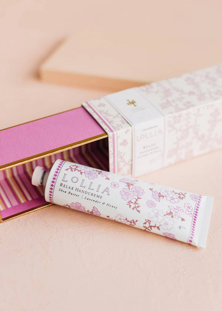 Open box for relax hand cream with tube of hand cream set next to it.