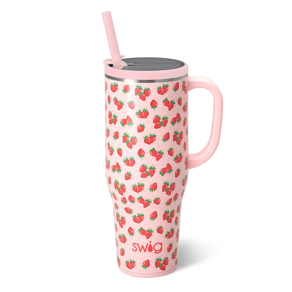 Pink insulated tumbler with pink straw and pink handle and red strawberry design all over it