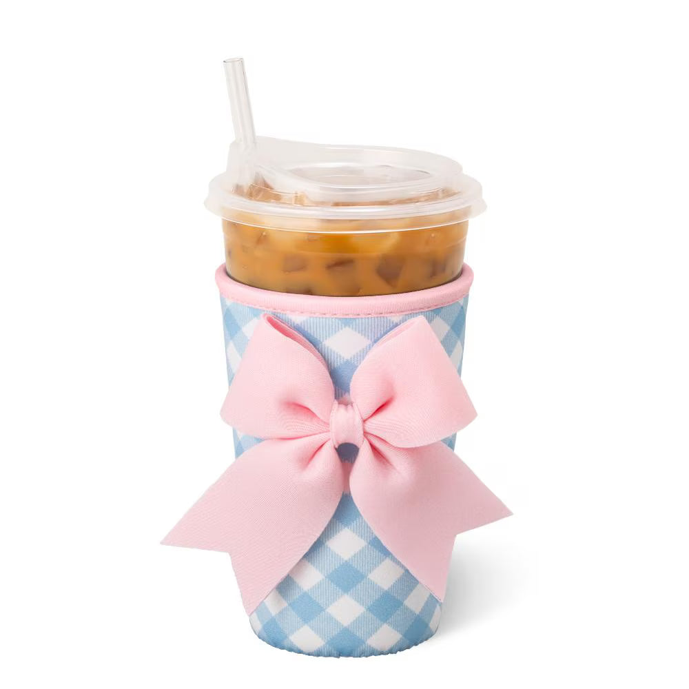 Iced beverage in a blue and white gingham sleeve with a pink bow on it.