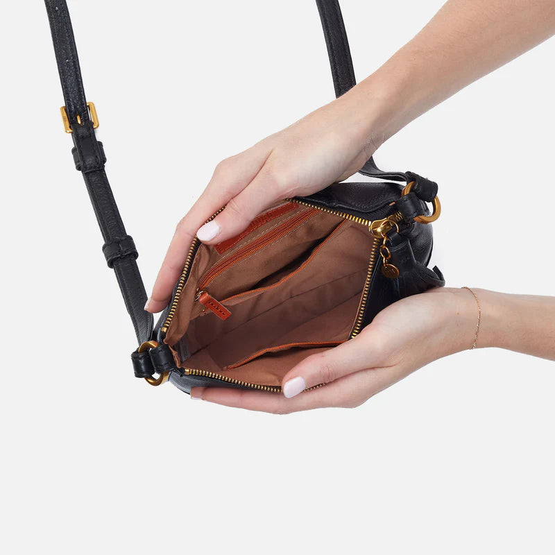 hands holding open black Lexi Crossbody showing interior