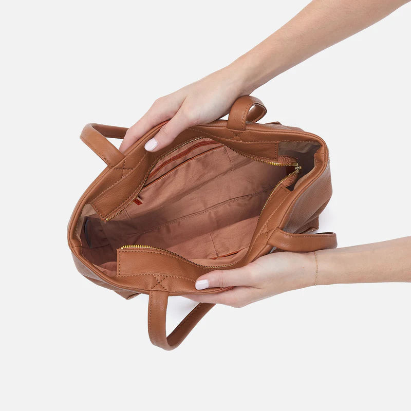 hands holding open warm honey Austin Tote showing interior