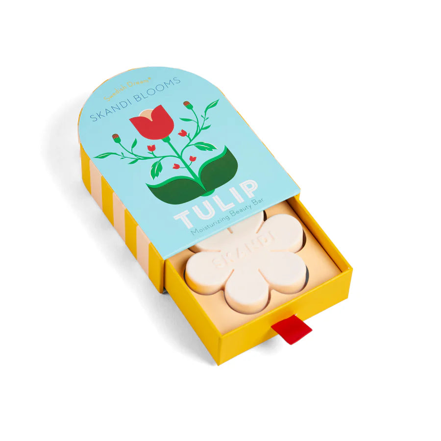 Blue box with floral design slightly open showing flower shaped bar of soap inside.