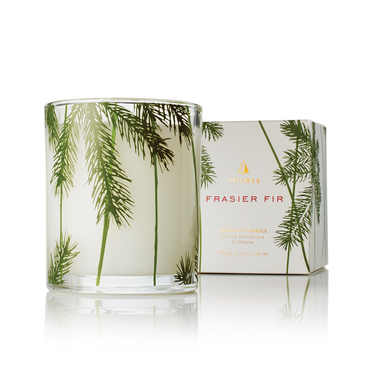 thymes fraiser fir candle in front of its box on a white background