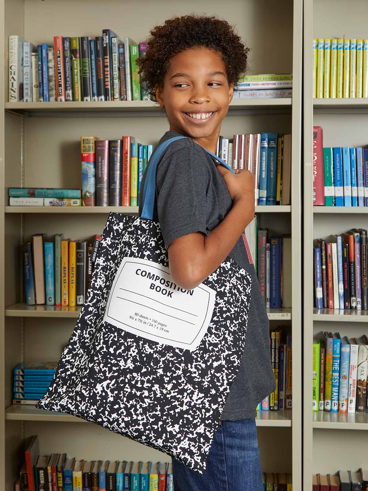 a person wearing the composition notebook on their shoulder