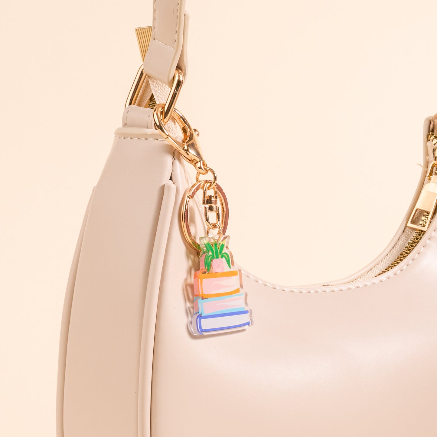 Acrylic book Nook keychain on a pink purse
