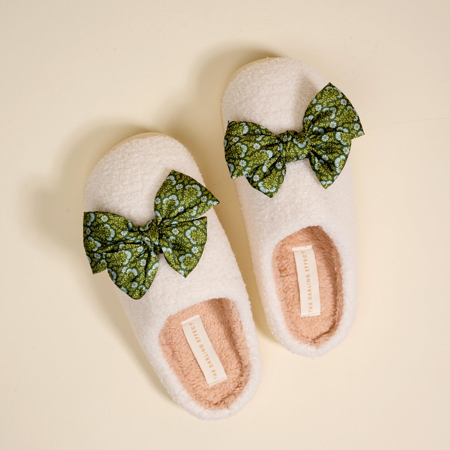 Fuzzy Slippers, Betty Bow Everbloom Forest Green on a beige background