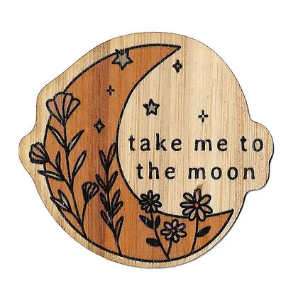 orange crescent moon with flowers and stars on it and text "take me to the moon" next to the moon