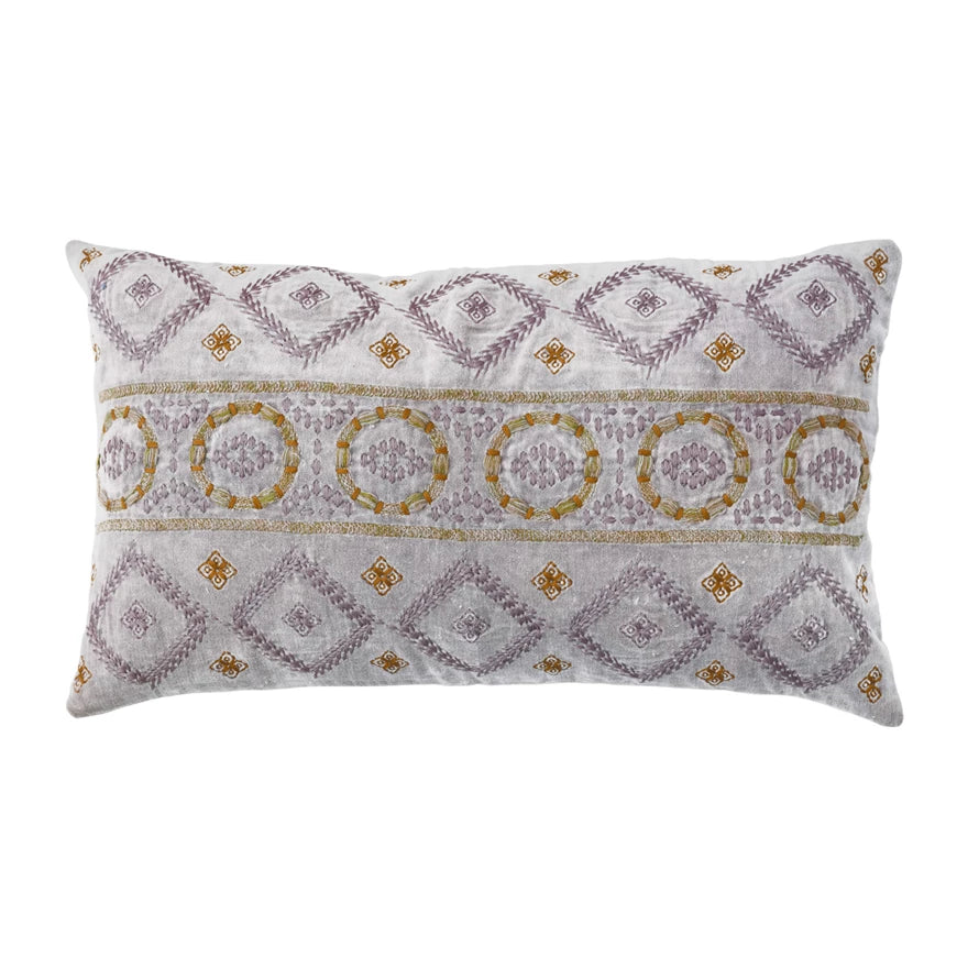 lavender pillow with embroidered pattern on a white background.
