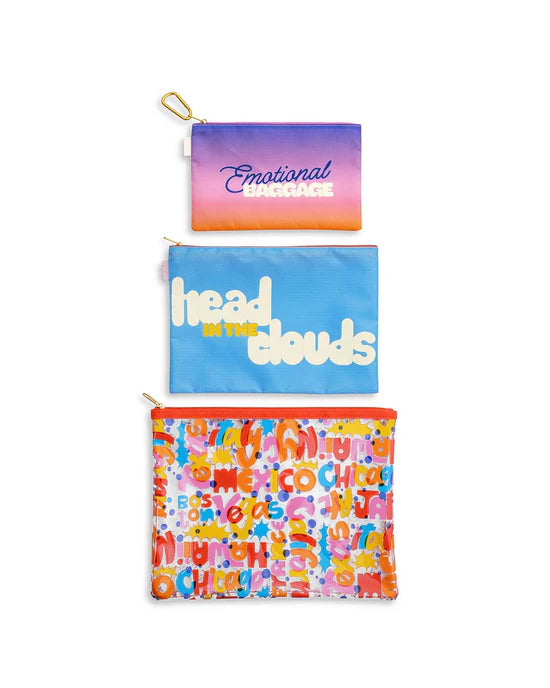 small "emotional baggage" zipper bag, Medium blue "head in the clouds" zipper bag, large clear zipper bag with various desinations printed on it.