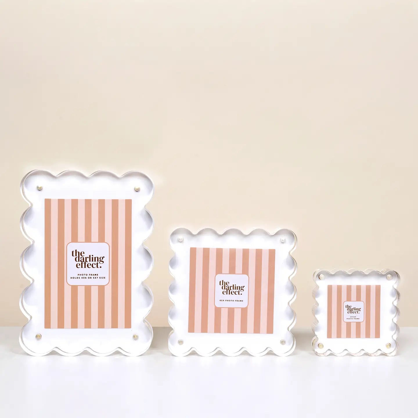 Three sizes of decorative frames with scalloped edges and striped design on a beige background