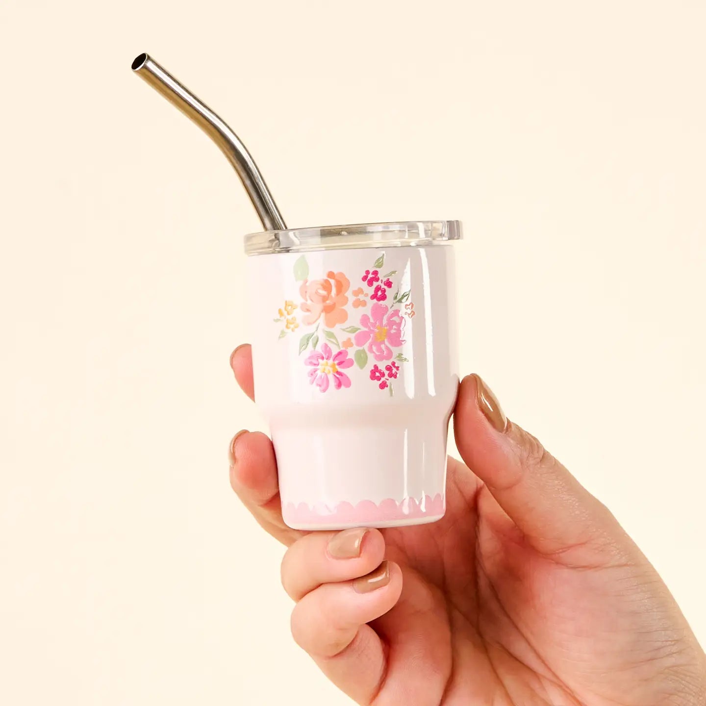 hand holding Pink Garden Blooms tiny tumbler