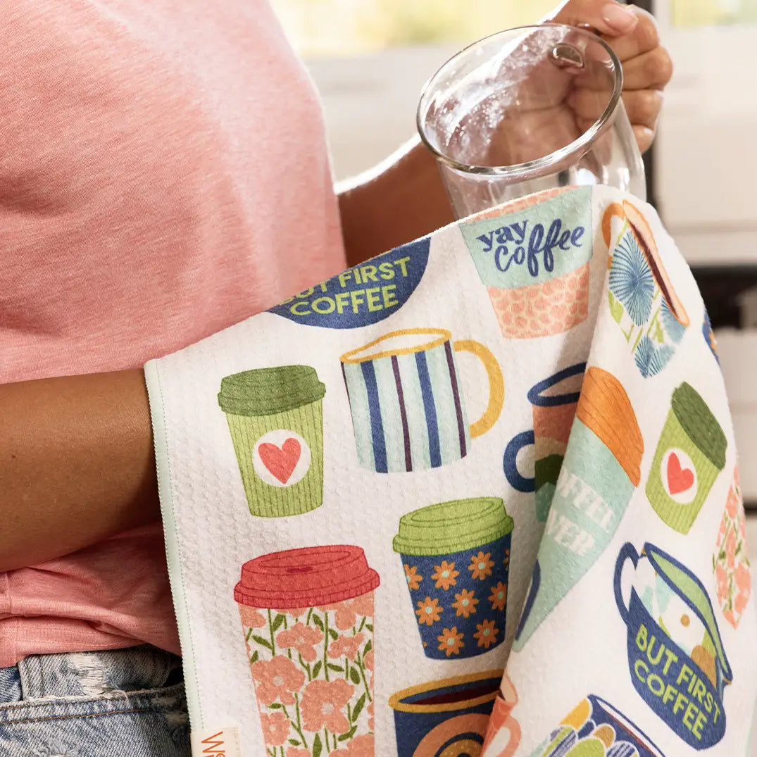 Person using coffee dish towel to dry a glass.