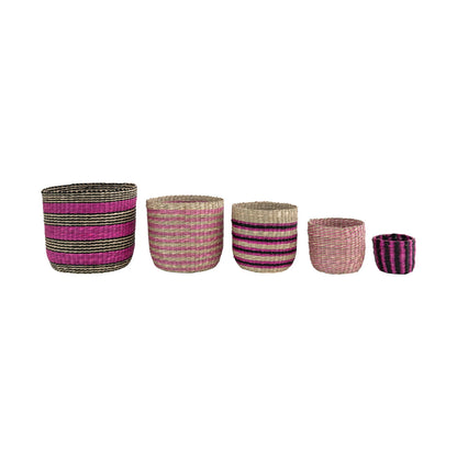 5 sizes and styles of seagrass baskets in a row on a white background.