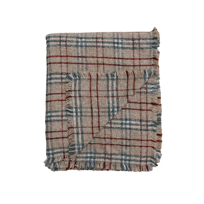 plaid blanket folded with a corner flapped over.