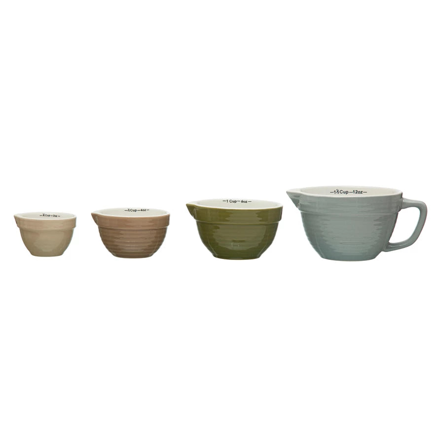 Stoneware Measuring Cups in a row on a white background