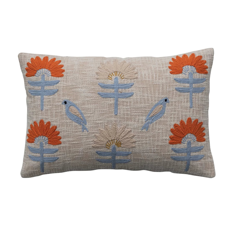 cotton pillow with embroidered flowers and birds on it.