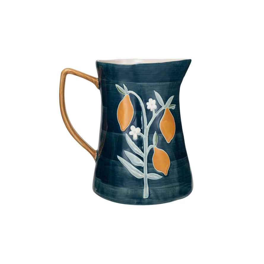 blue Pitcher with Flowers & Lemons on a white background.