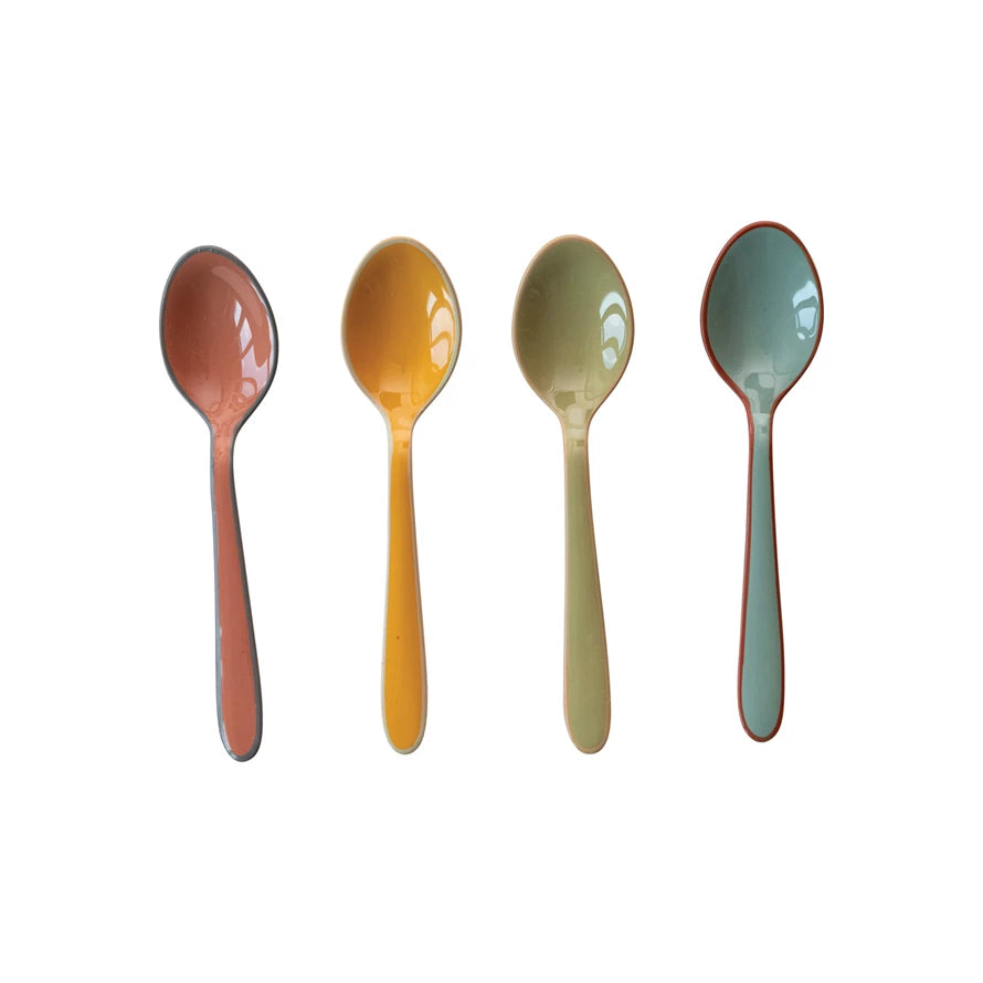 4 colors of spoons of a white background.