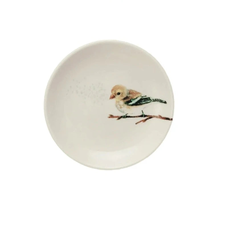 white-white plate with little brown bird sitting on a branch.